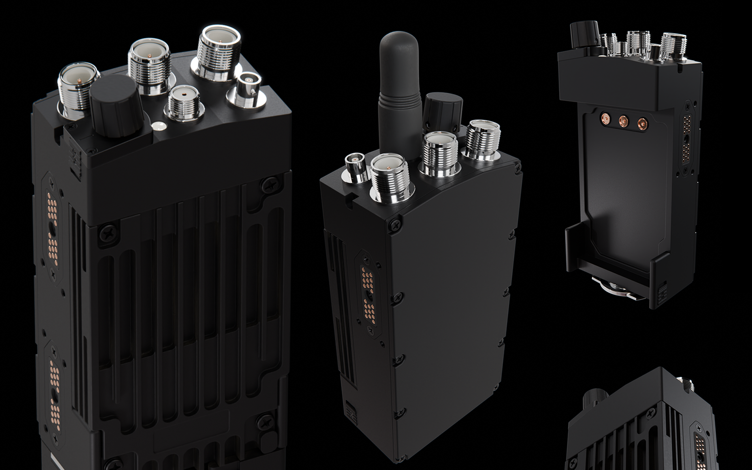 Black handheld radio units stood on end against a black background, their threaded metal antenna connectors catching the light, with one unit held in its mounting cradle.